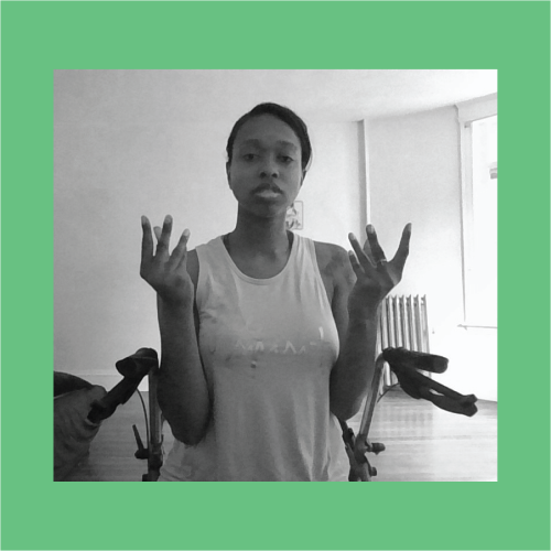 A black and white image on a green background of a woman with her hands and fingers up as she talks.