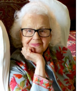 A photo of artist Helga Roht Poznanski sitting in an armchair.