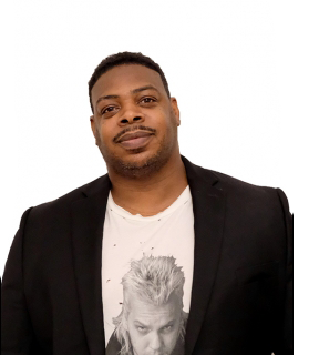 A headshot of artist Lavaughan Jenkins in front of a white background.